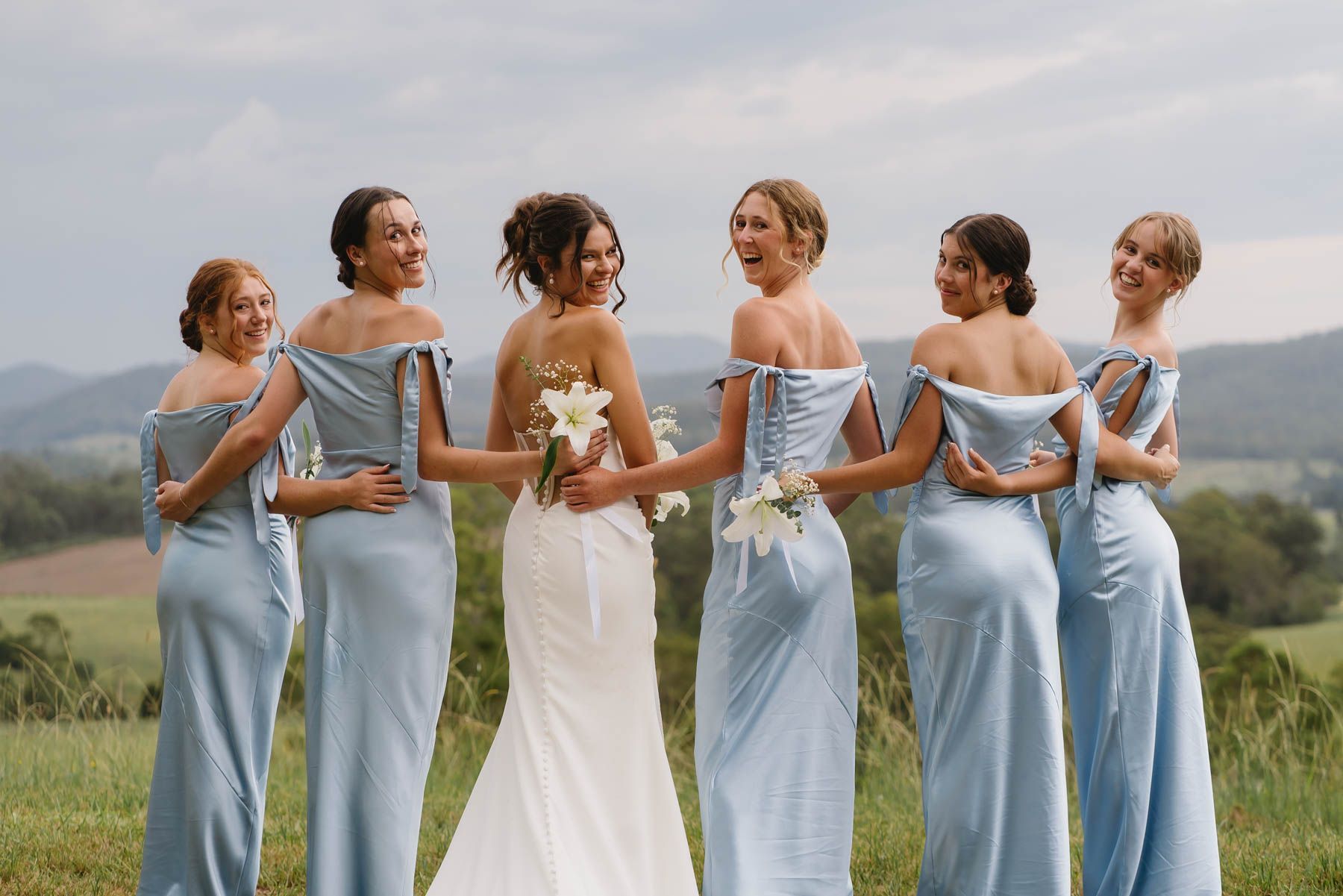 Bride, groom, and grooms man drinking around a table