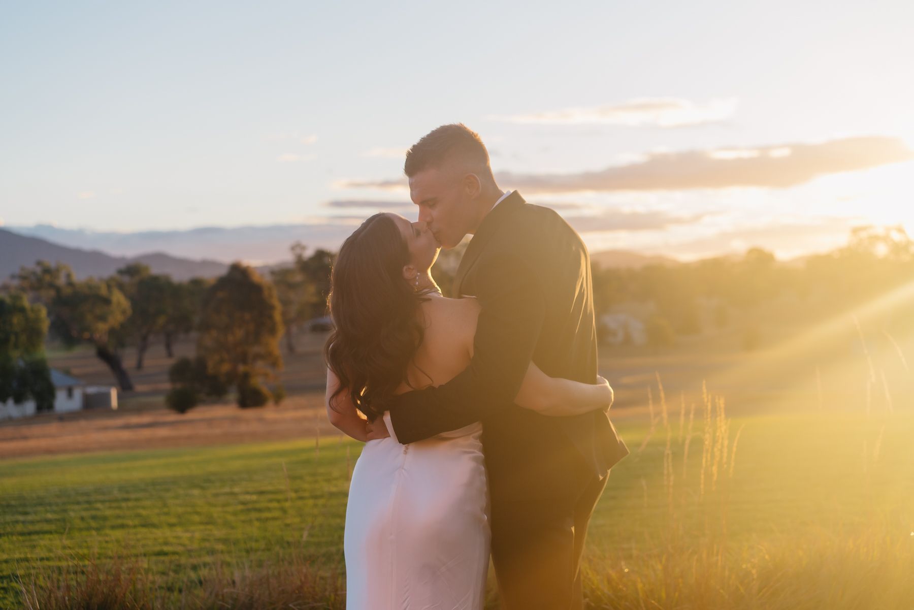 A Bride and Groom Are Posing for A Picture with Their Bridesmaids Lying on the Ground Looking up— Seed + Salt Photography In Smithtown, NSW