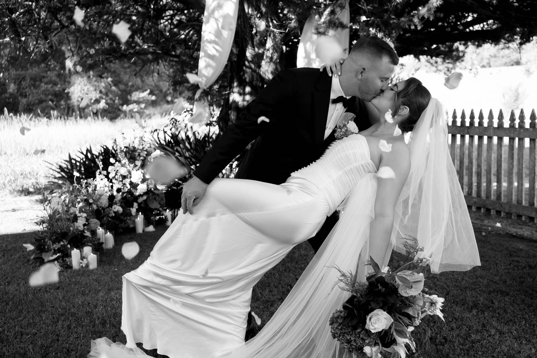 A Black and White Photo of A Bride and Groom With Sunglasses on Walking Through 2 Lines of People Holing Sparklers — Seed + Salt Photography In Smithtown, NSW