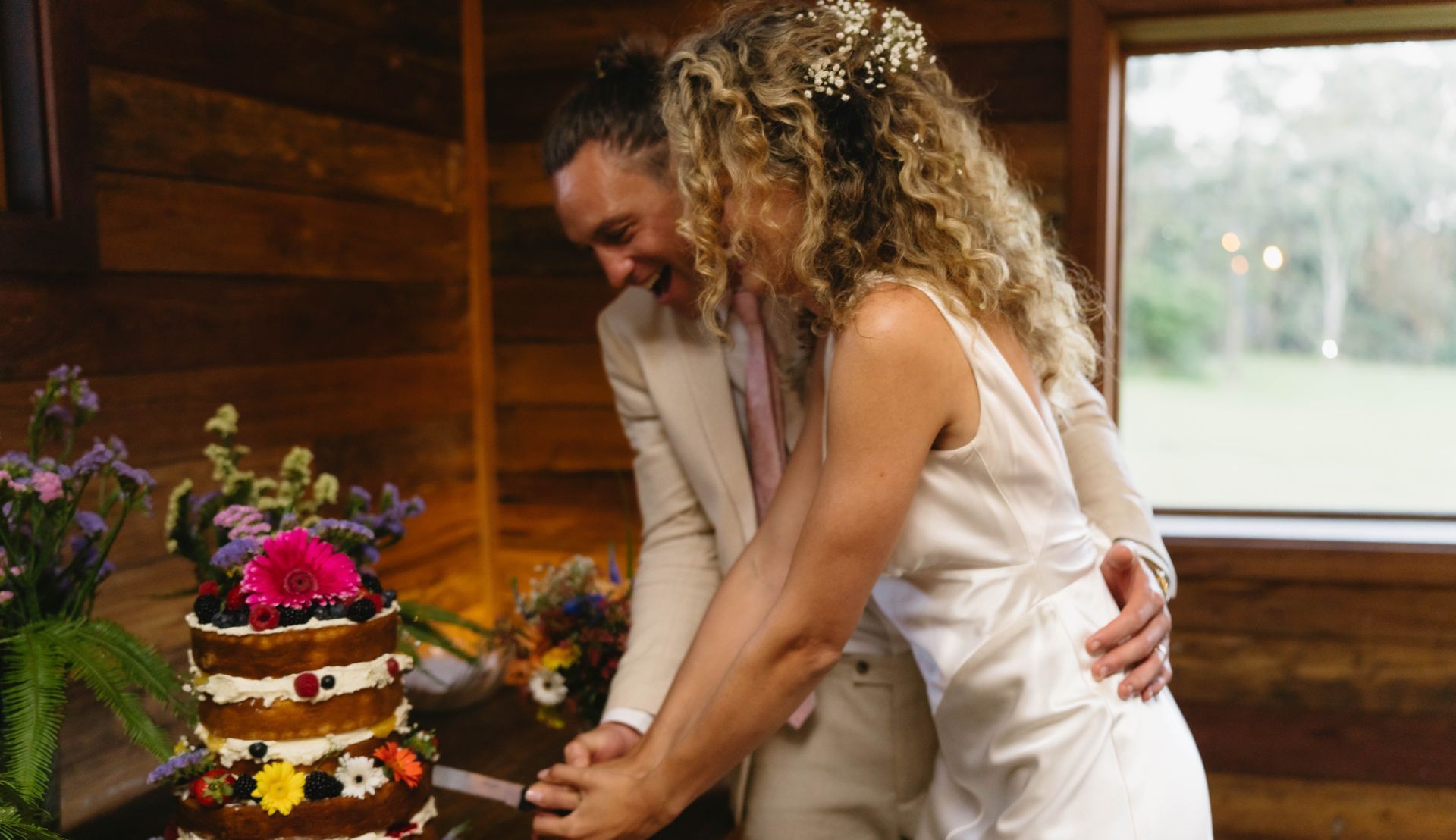 Bride and groom cutting wedding cake — Seed + Salt Photography In Smithtown, NSW