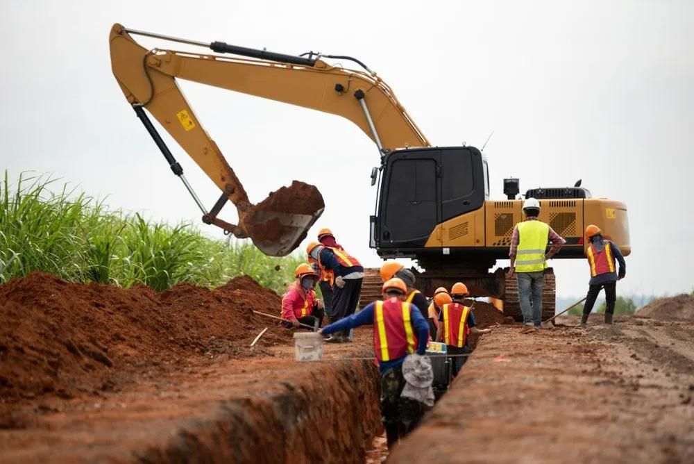 A Group of Construction Workers Are Working on A Construction Site — Gillespie Plumbing in Grafton, NSW
