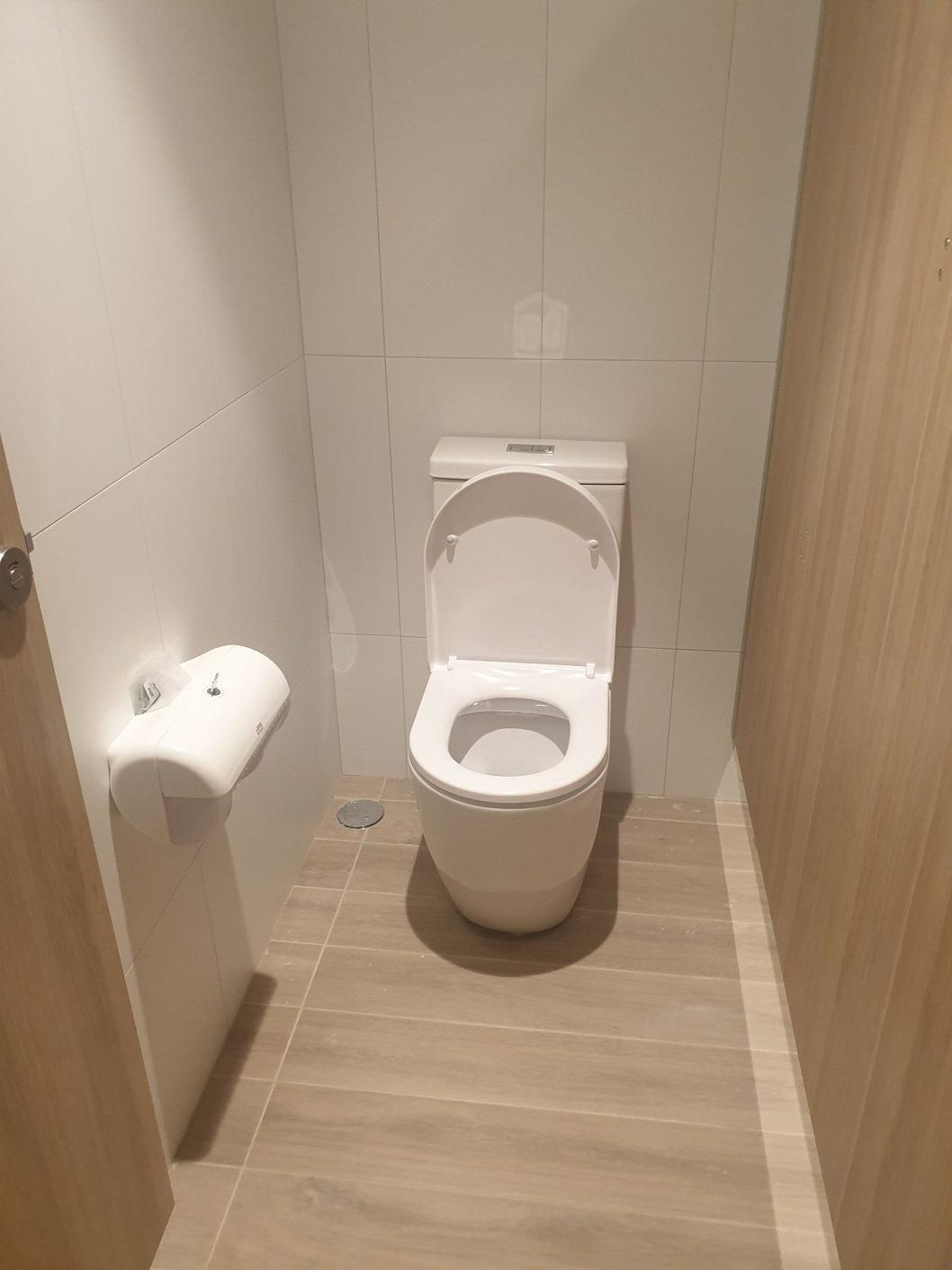 There Is a Toilet in The Bathroom with A Wooden Floor — Gillespie Plumbing in Grafton, NSW
