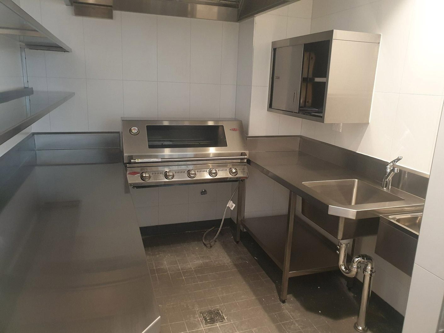 A Kitchen with A Stove and Sink in It — Gillespie Plumbing in Grafton, NSW