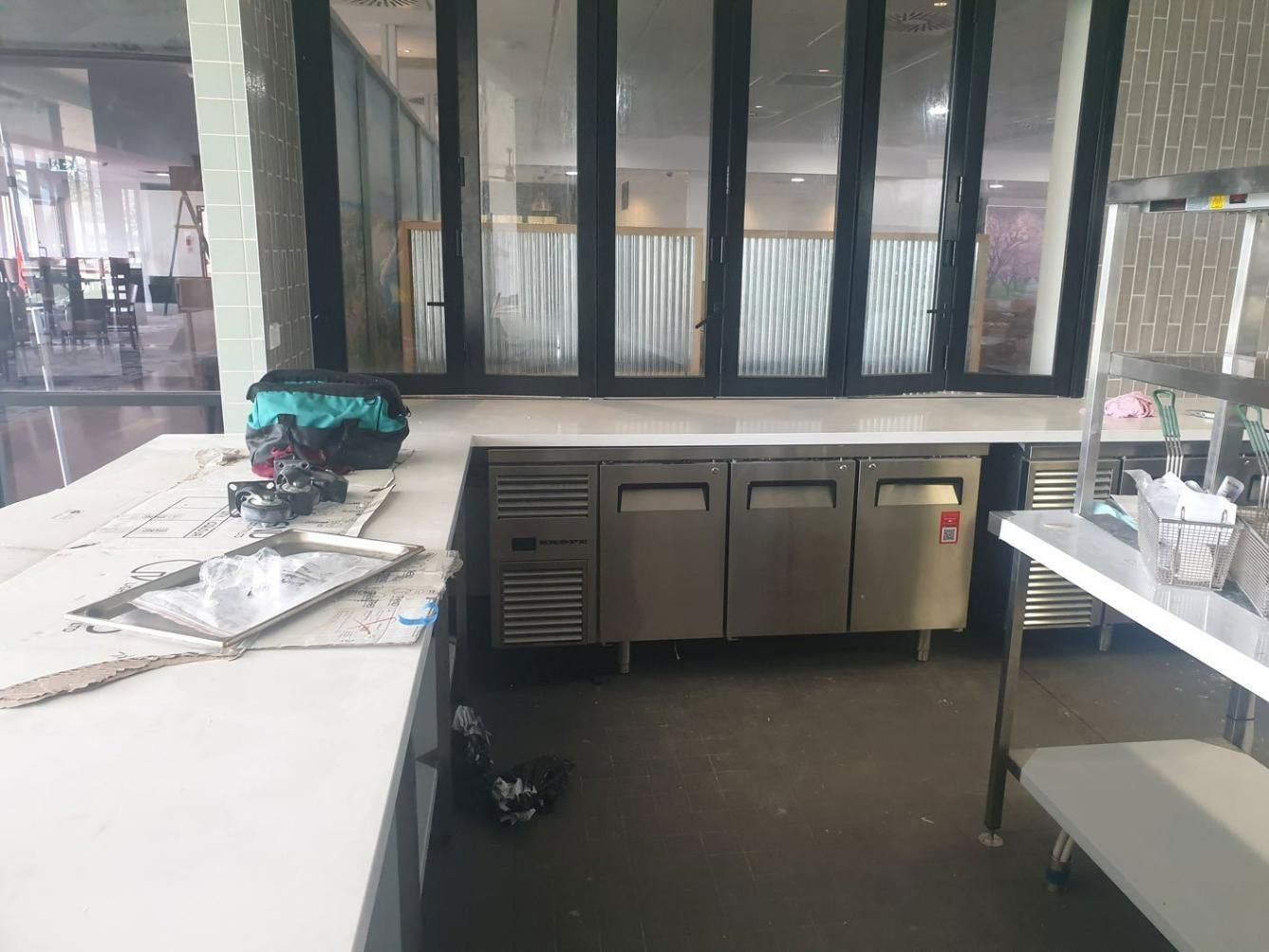 A Kitchen with Stainless Steel Appliances and A Large Window — Gillespie Plumbing in Grafton, NSW