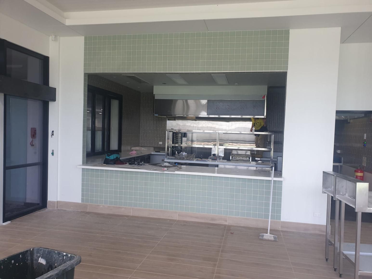 An Empty Kitchen with A Stainless Steel Counter Top — Gillespie Plumbing in Grafton, NSW