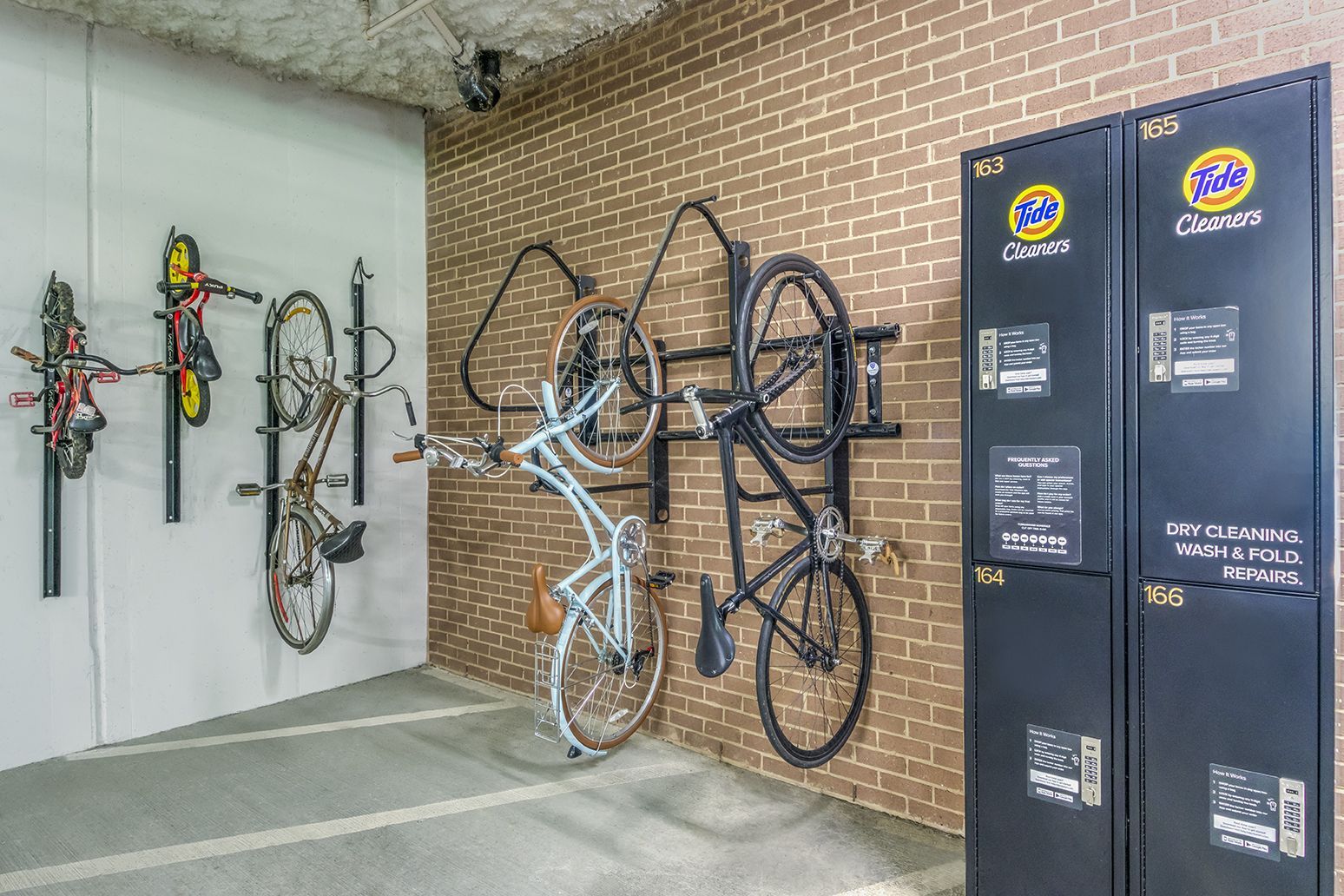 Bikes mounted on walls in a room, next to Tide lockers.