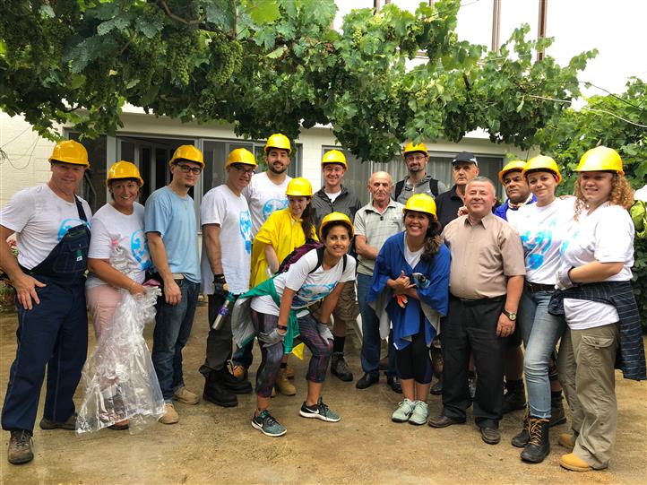 A group of people wearing hard hats are posing for a picture.