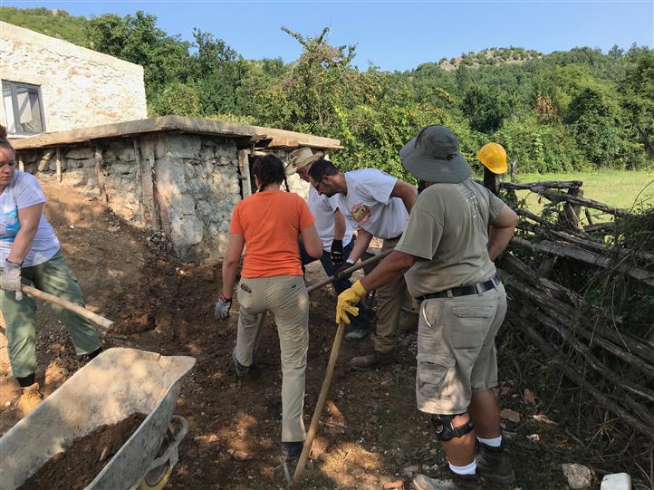 A group of people are digging in the dirt.