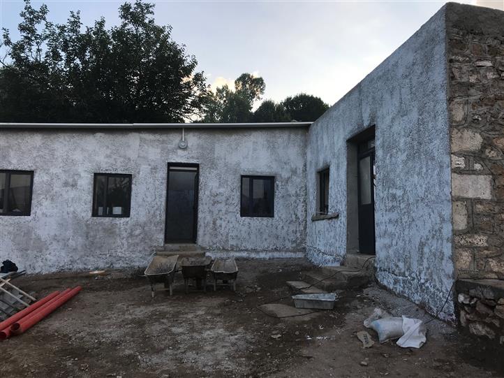 A white building with a black door and windows