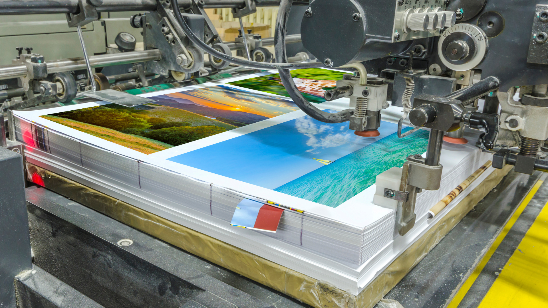 A stack of papers is being printed on a machine.