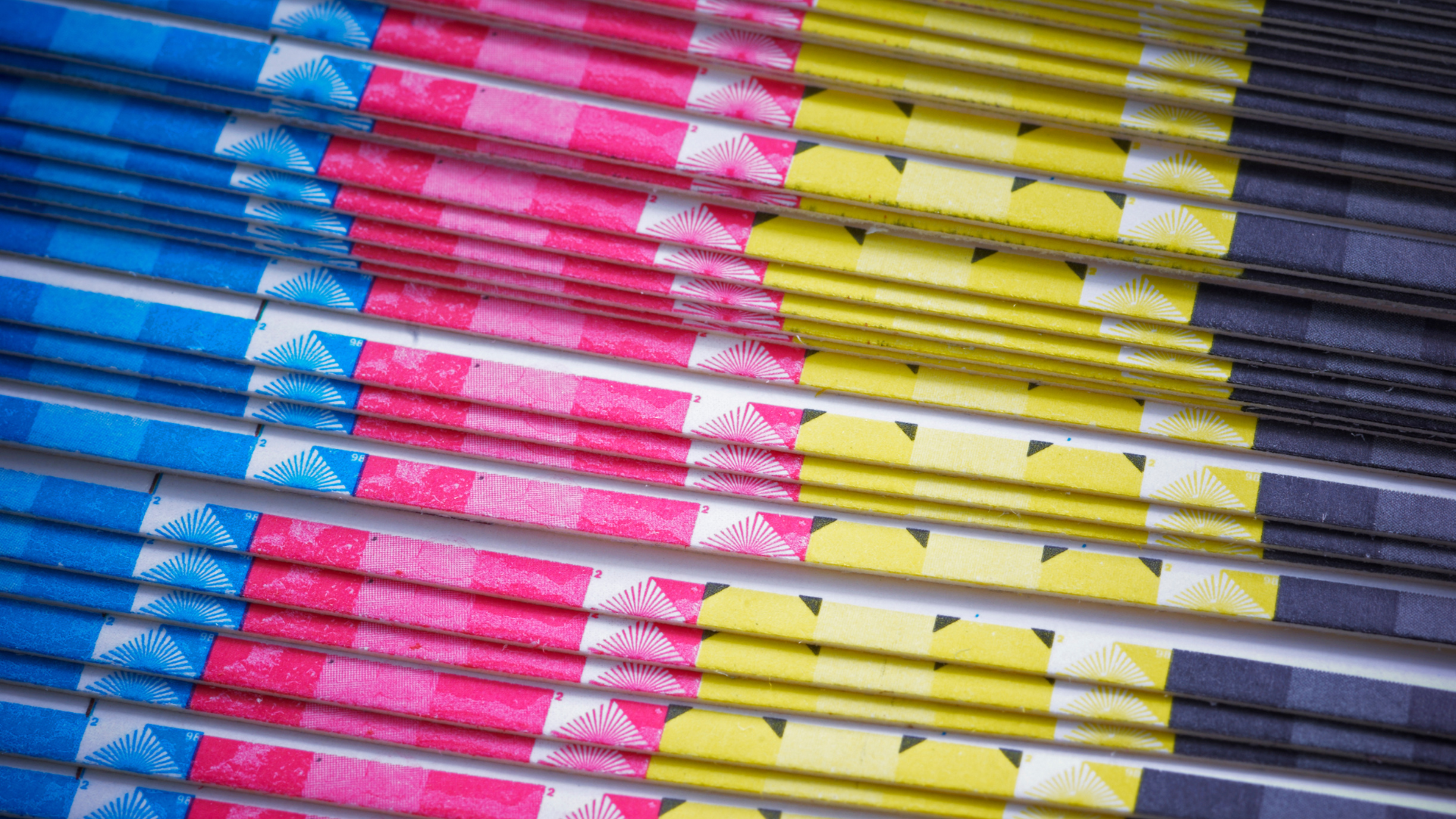 A close up of a stack of pencils with different colors on them.