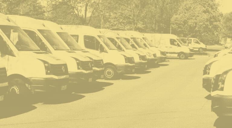 White vans are parked | Joyce Automotive and Towing