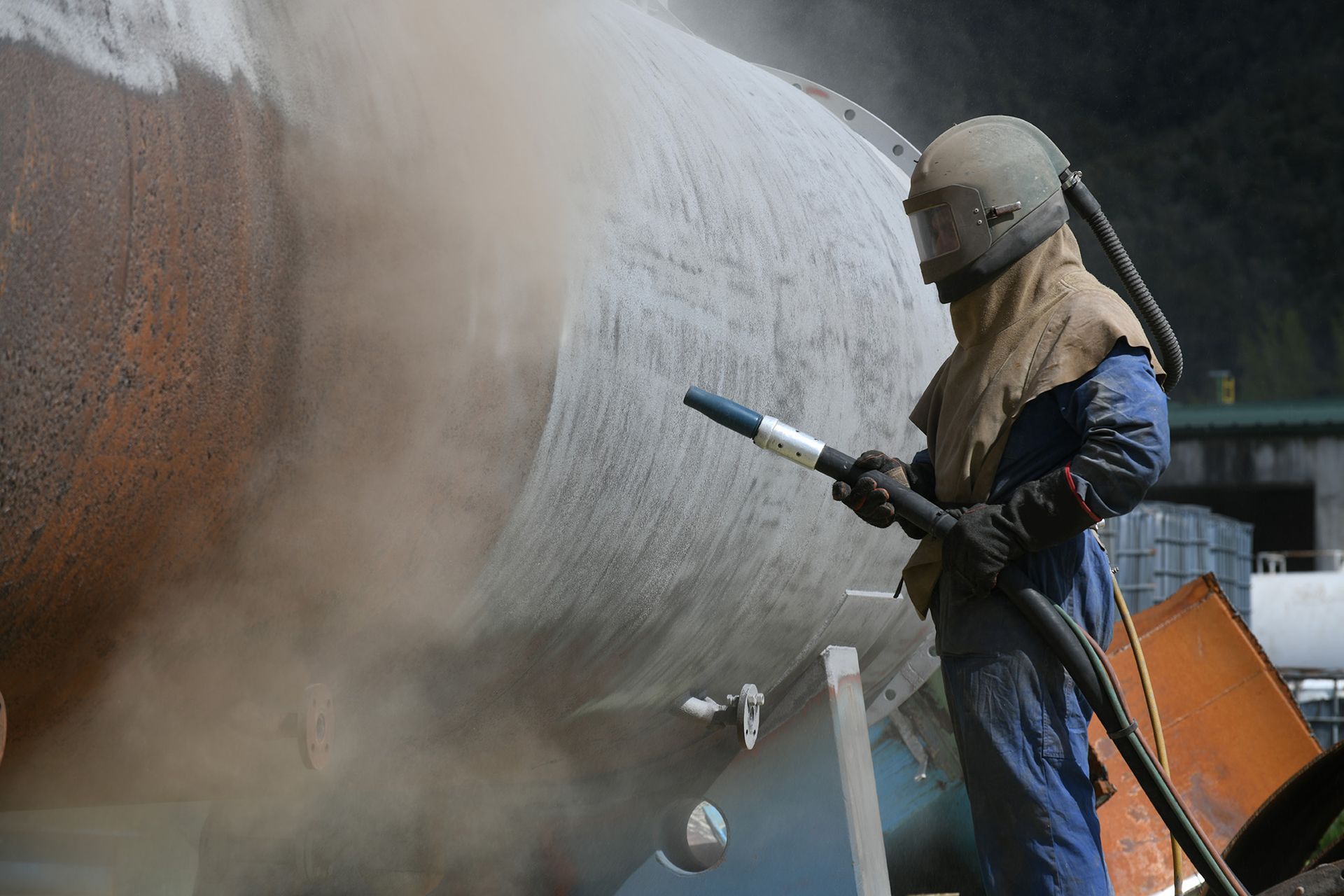 A man is working on a pipe with a crane.