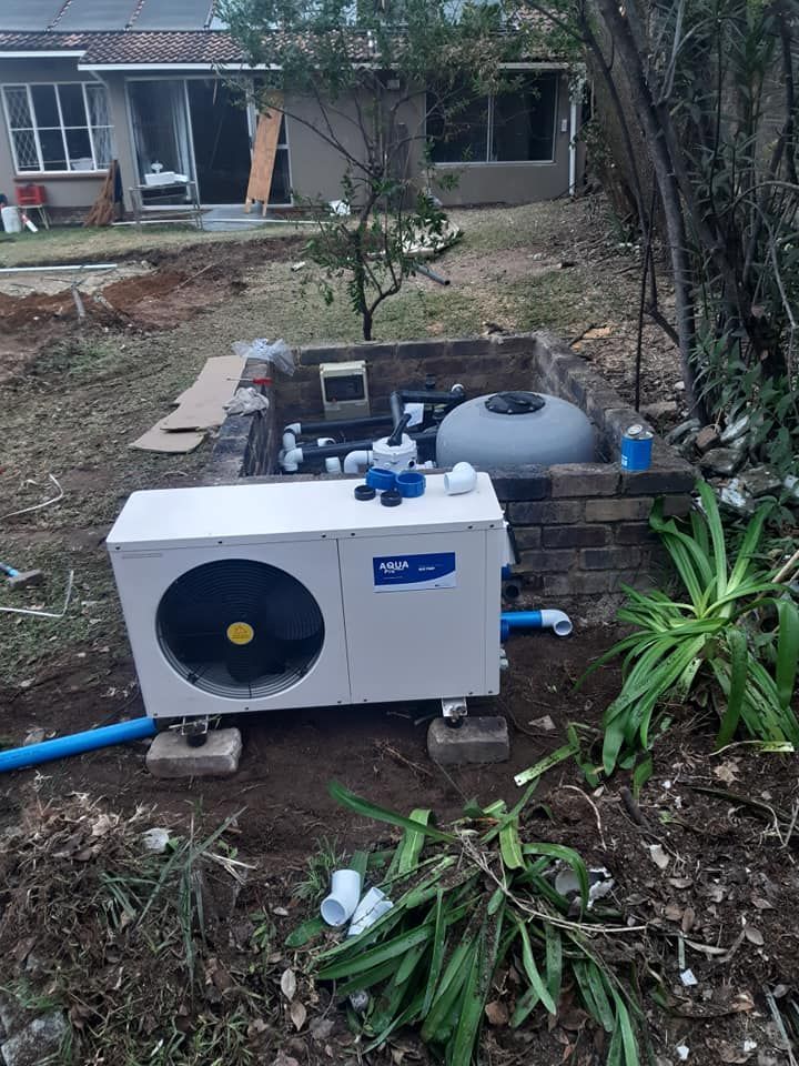 Pool pump and filter system installed outdoors next to a partially built pool.