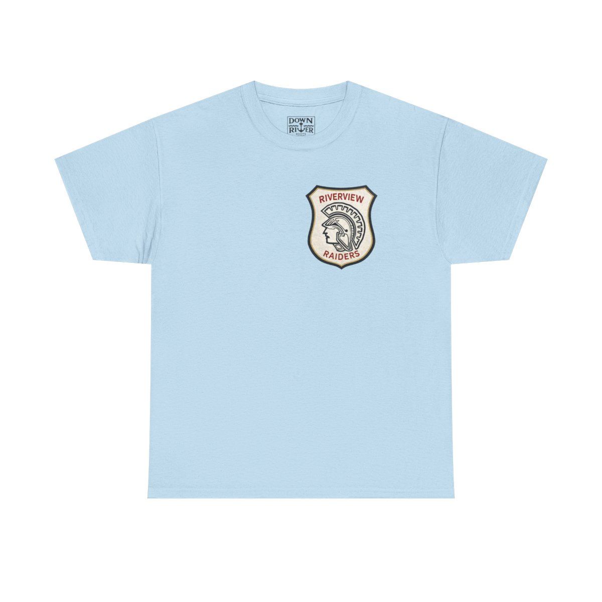 Light blue t-shirt with a cream and red shield patch on the chest.