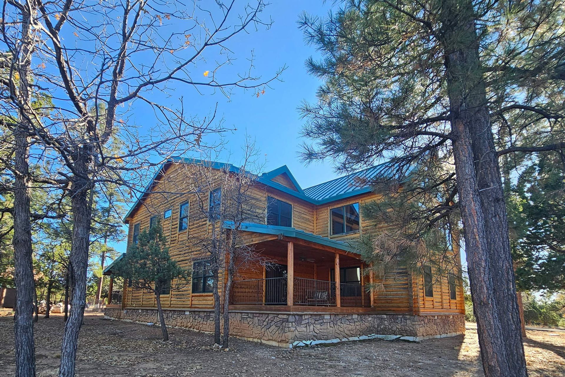 Wooden House With a Blue Roof — Flagstaff, AZ — Northern Arizona Building and Investments