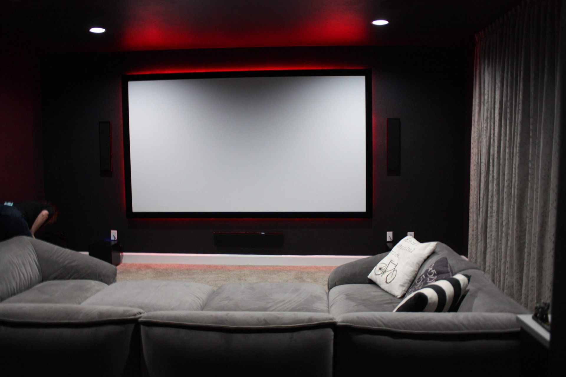 Home Theater With a Projector Screen and a Couch — Austin, TX — ACA Electronics Inc.