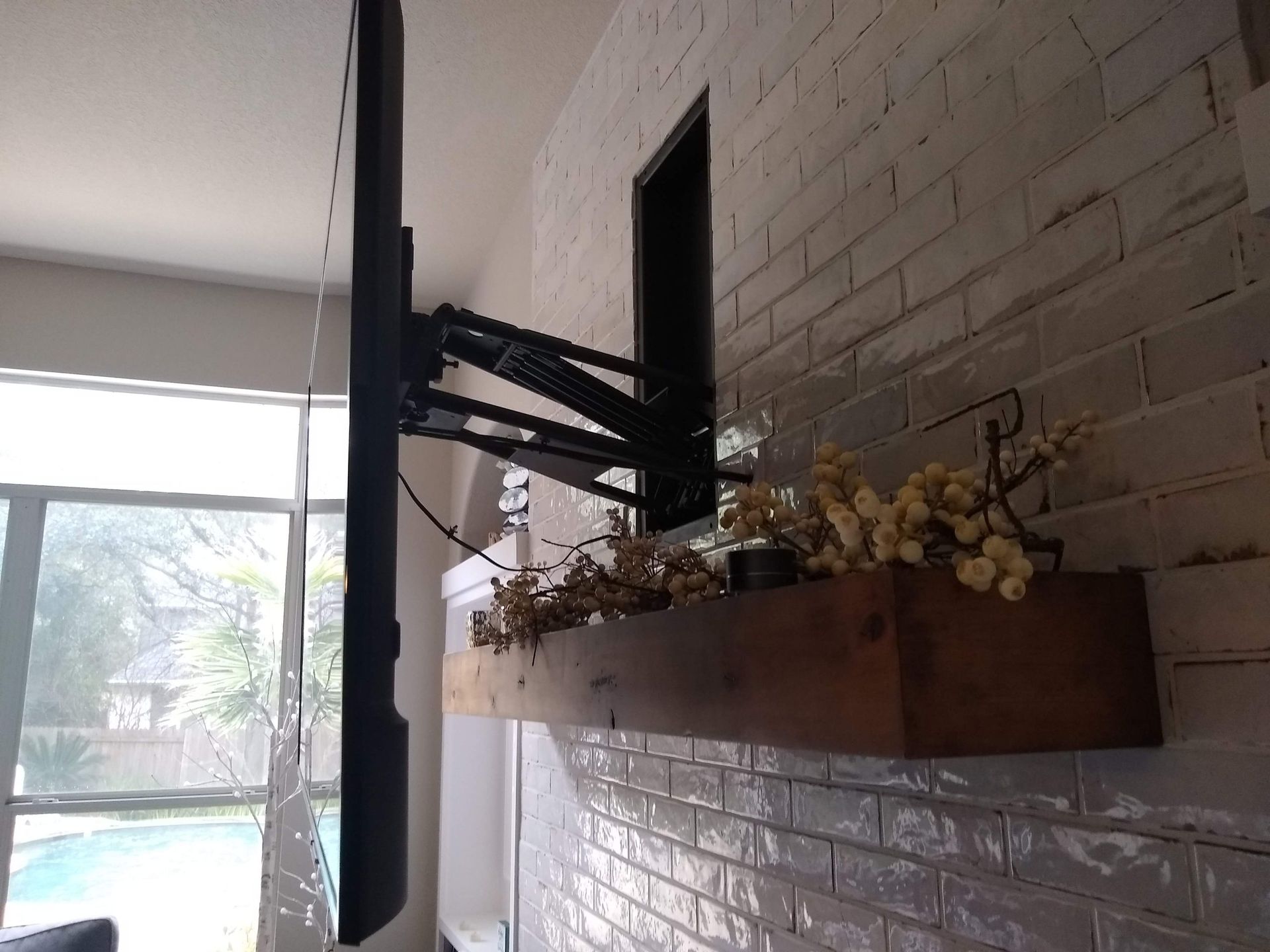 Flat Screen TV Mounted on a Brick Wall in a Living Room — Austin, TX — ACA Electronics Inc.