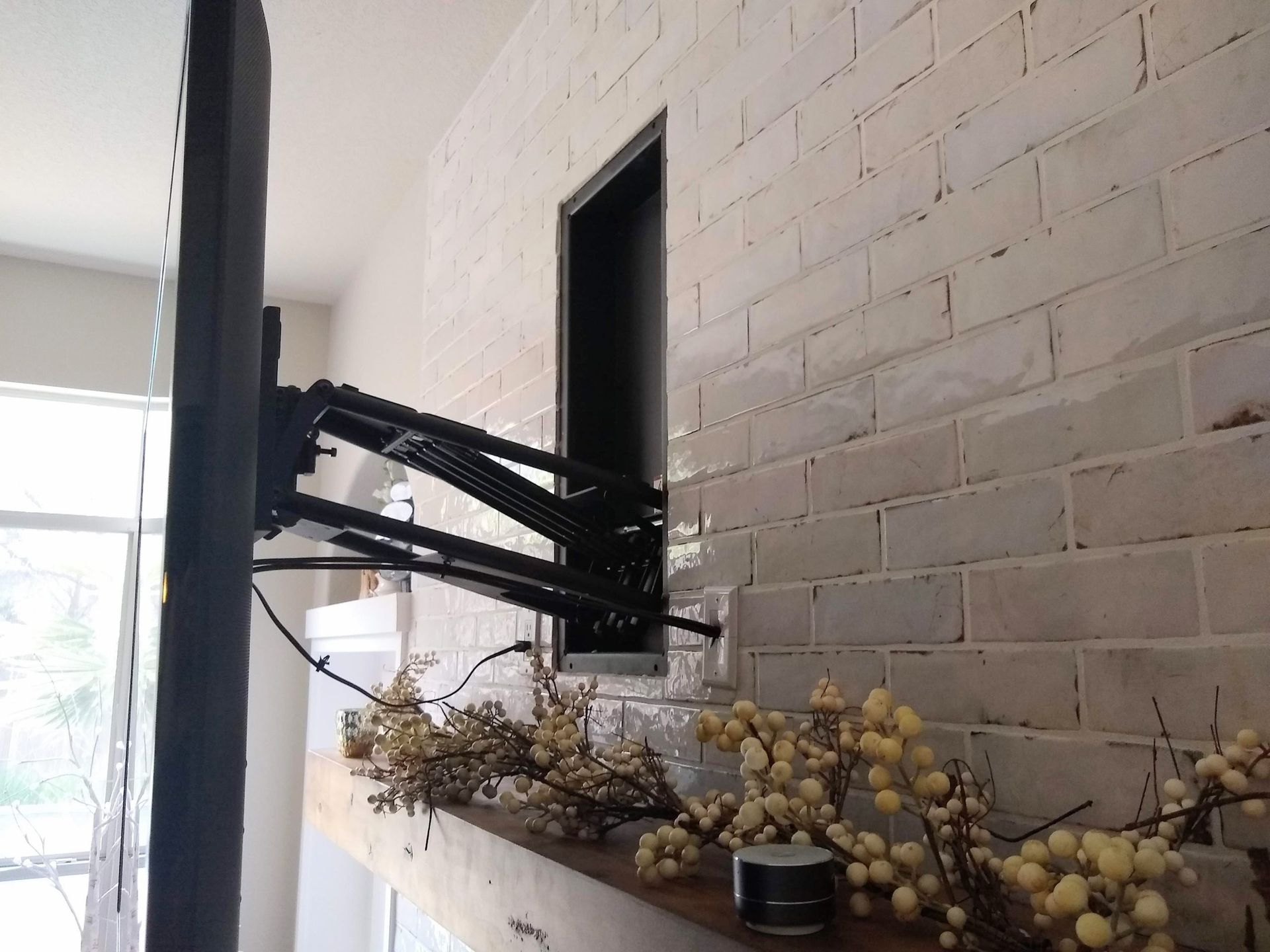 TV Mounted to a White Brick Wall — Austin, TX — ACA Electronics Inc.