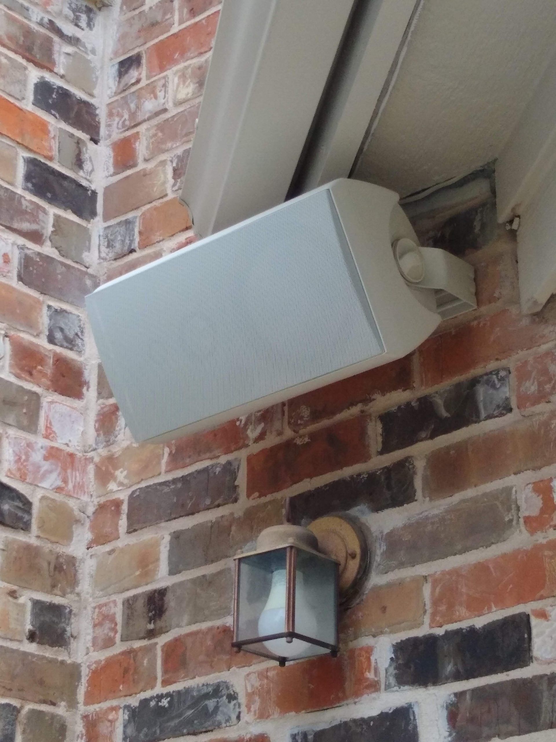 White Speaker is Mounted on a Brick Wall — Austin, TX — ACA Electronics Inc.