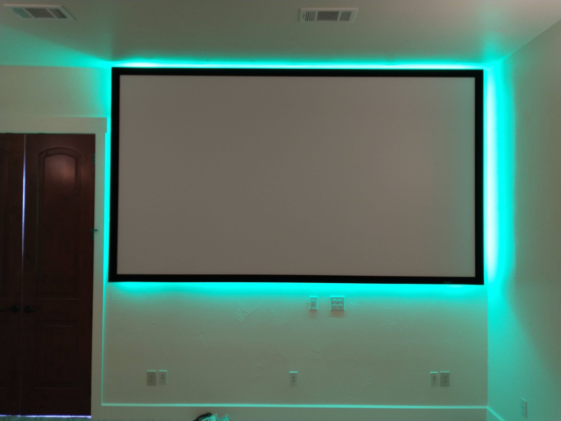 Projector Screen is Surrounded by Green Lights in a Room — Austin, TX — ACA Electronics Inc.