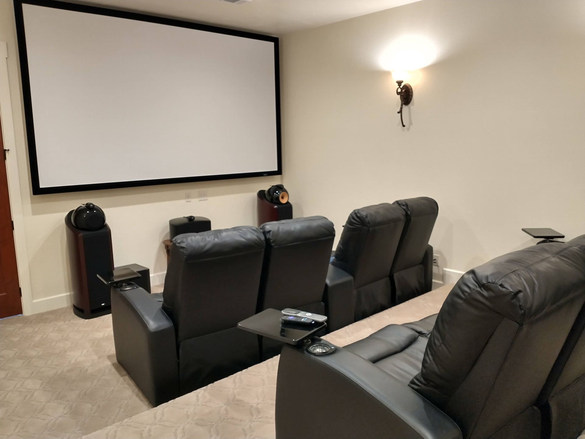 Home Theater With a Large Screen and Black Leather Seats — Austin, TX — ACA Electronics Inc.