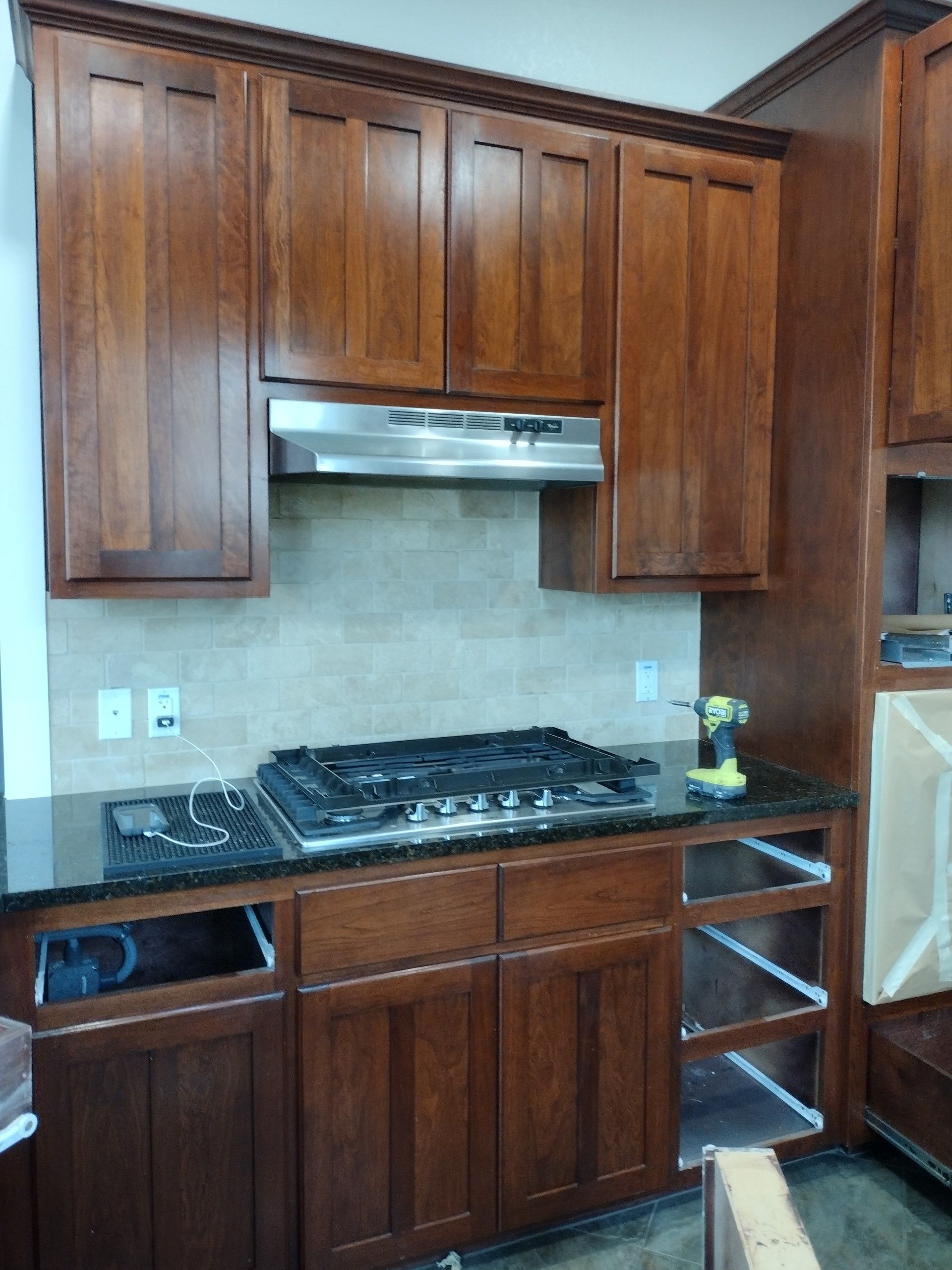 Kitchen With Wooden Cabinets and a Stove Top Oven — Austin, TX — ACA Electronics Inc.