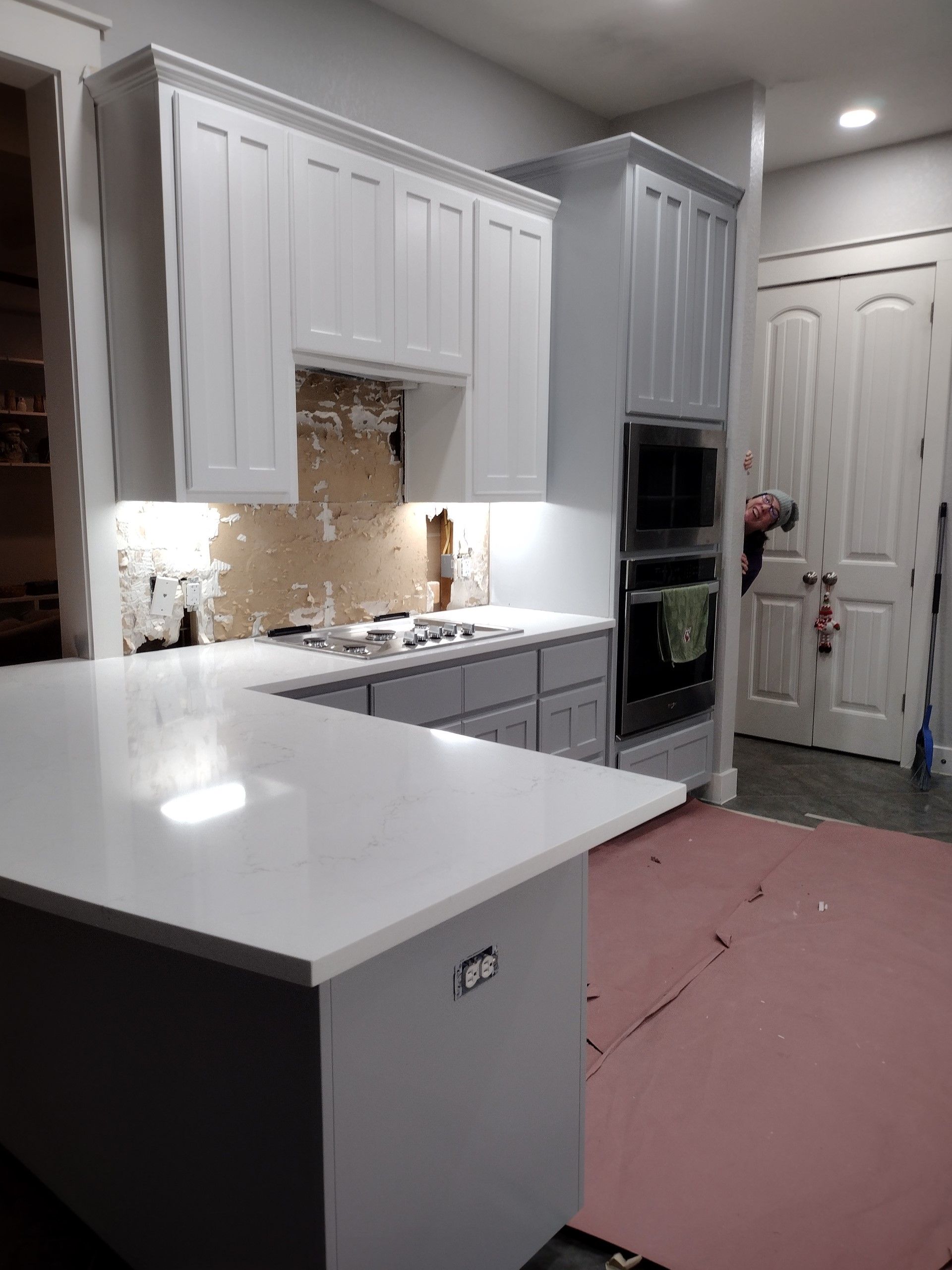 Kitchen With White Cabinets and a Pink Rug on the Floor — Austin, TX — ACA Electronics Inc.