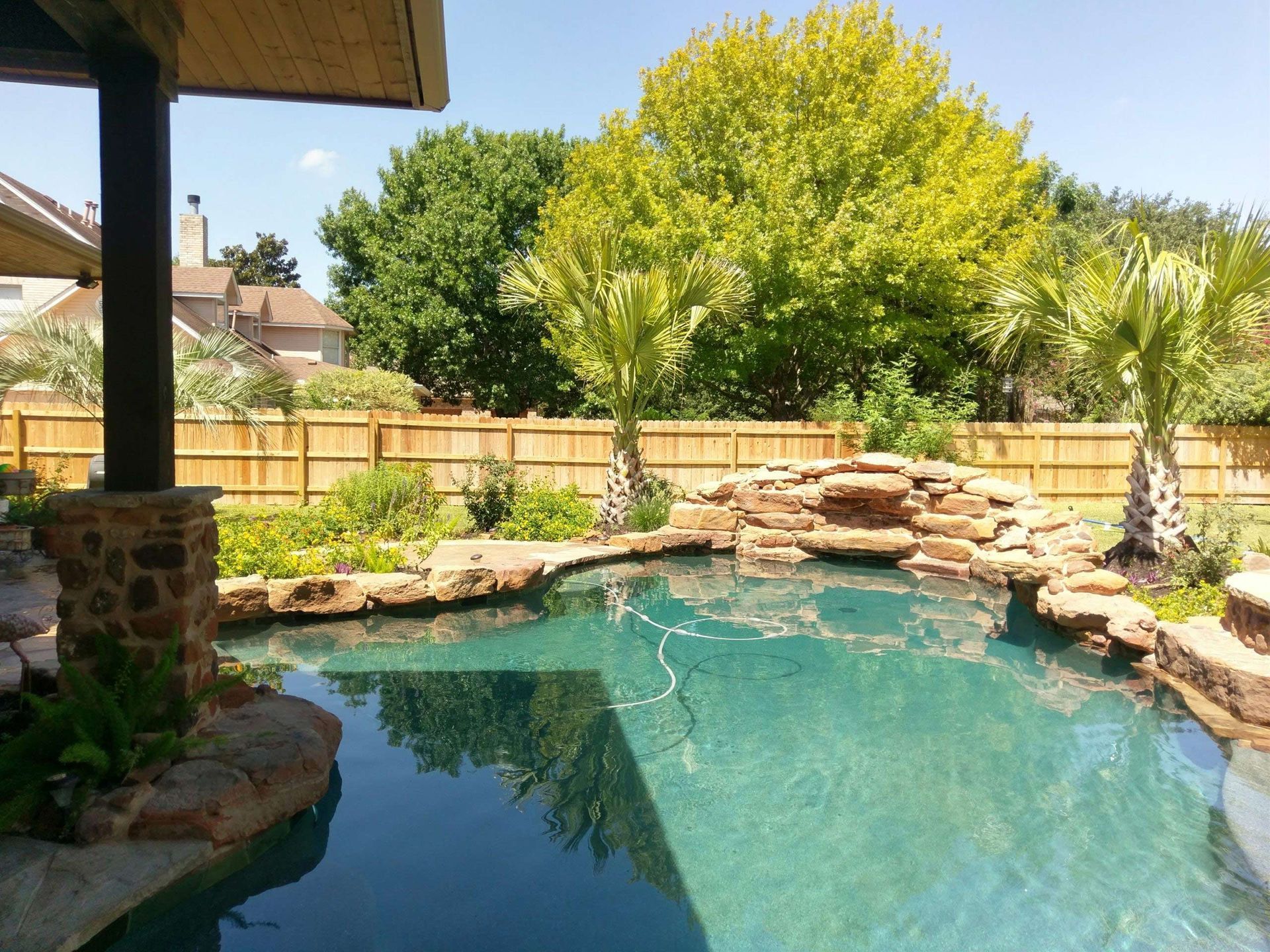 Large Swimming Pool With a Wooden Fence — Austin, TX — ACA Electronics Inc.