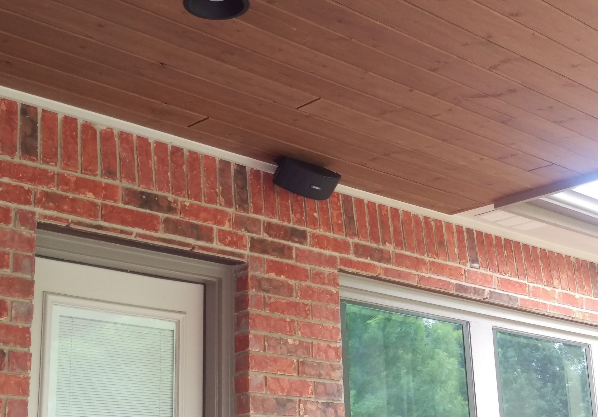 Brick Building With a Door and a Speaker on the Ceiling — Austin, TX — ACA Electronics Inc.