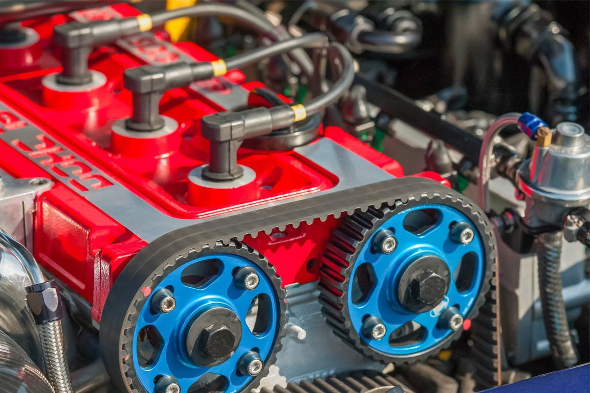 A close-up of a car engine with blue gears and spark plugs | Berkeley Bob's