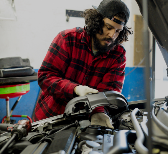 A  man is working on a car engine | Berkeley Bob's