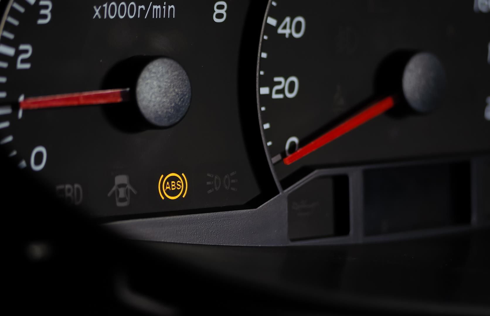 A close-up of a car dashboard with a brake light on | Berkeley Bob's