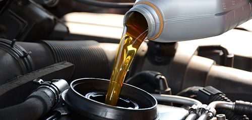 Oil being poured into a car engine | Berkeley Bob's