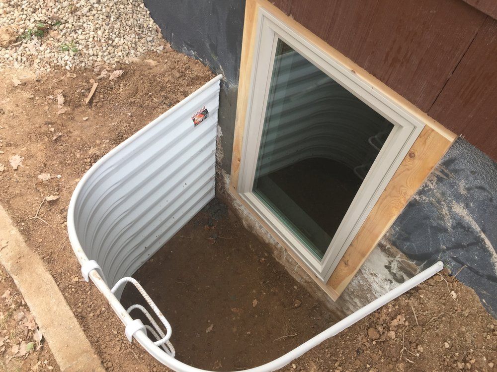 A window in a basement with a metal barrier around it