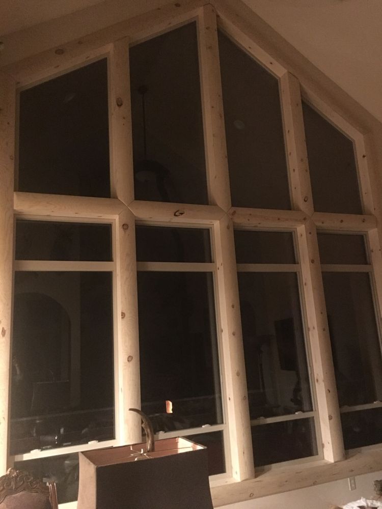 A living room with a lot of windows and a lamp