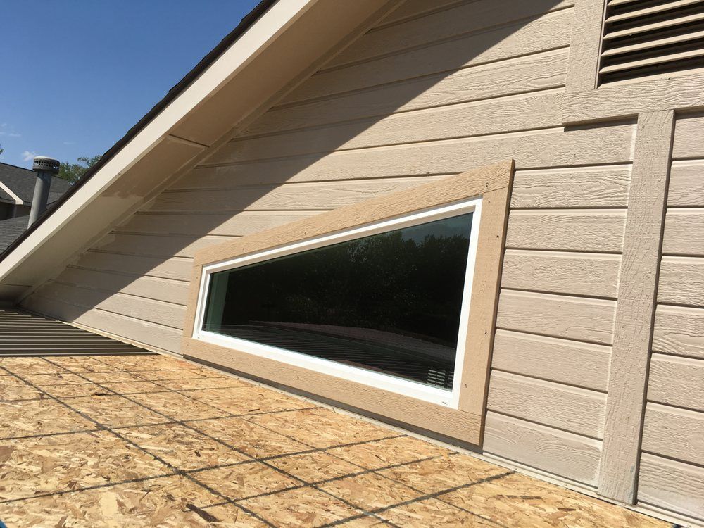 A house with a large window on the side of it.