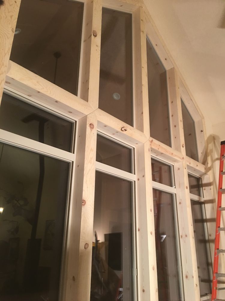 A room with a lot of windows and a ladder