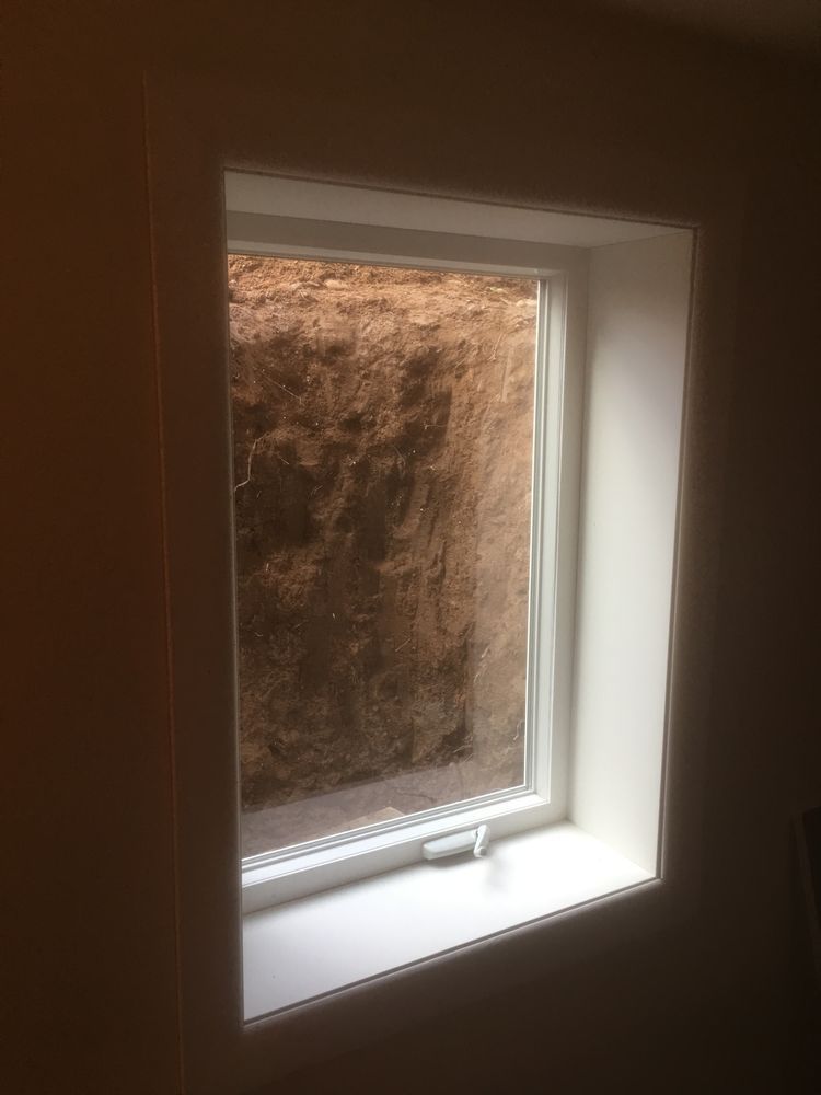 A window in a room with a view of a hole in the wall.