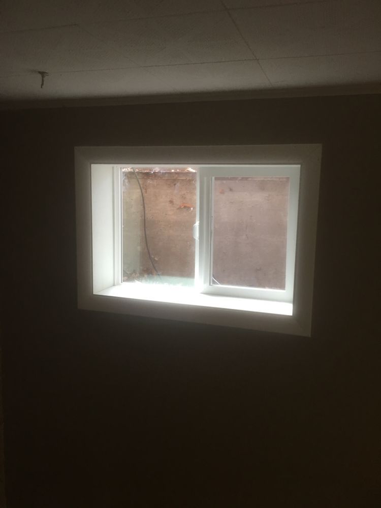 There is a window in the corner of a room.