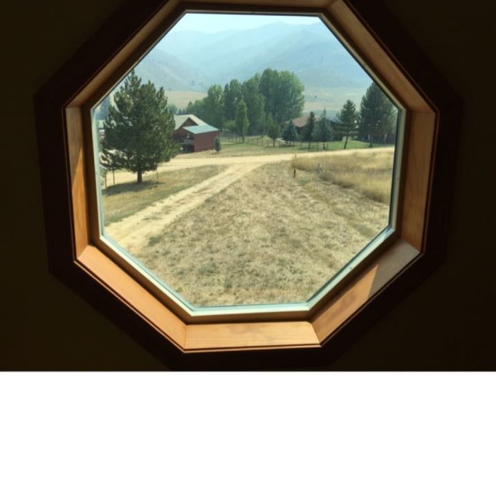 A view of a field through an octagonal window
