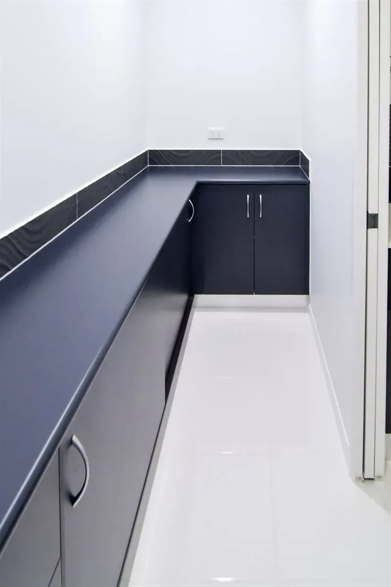 Gray Laundry Room With Cabinets — B & C Cabinets in Mareeba, QLD