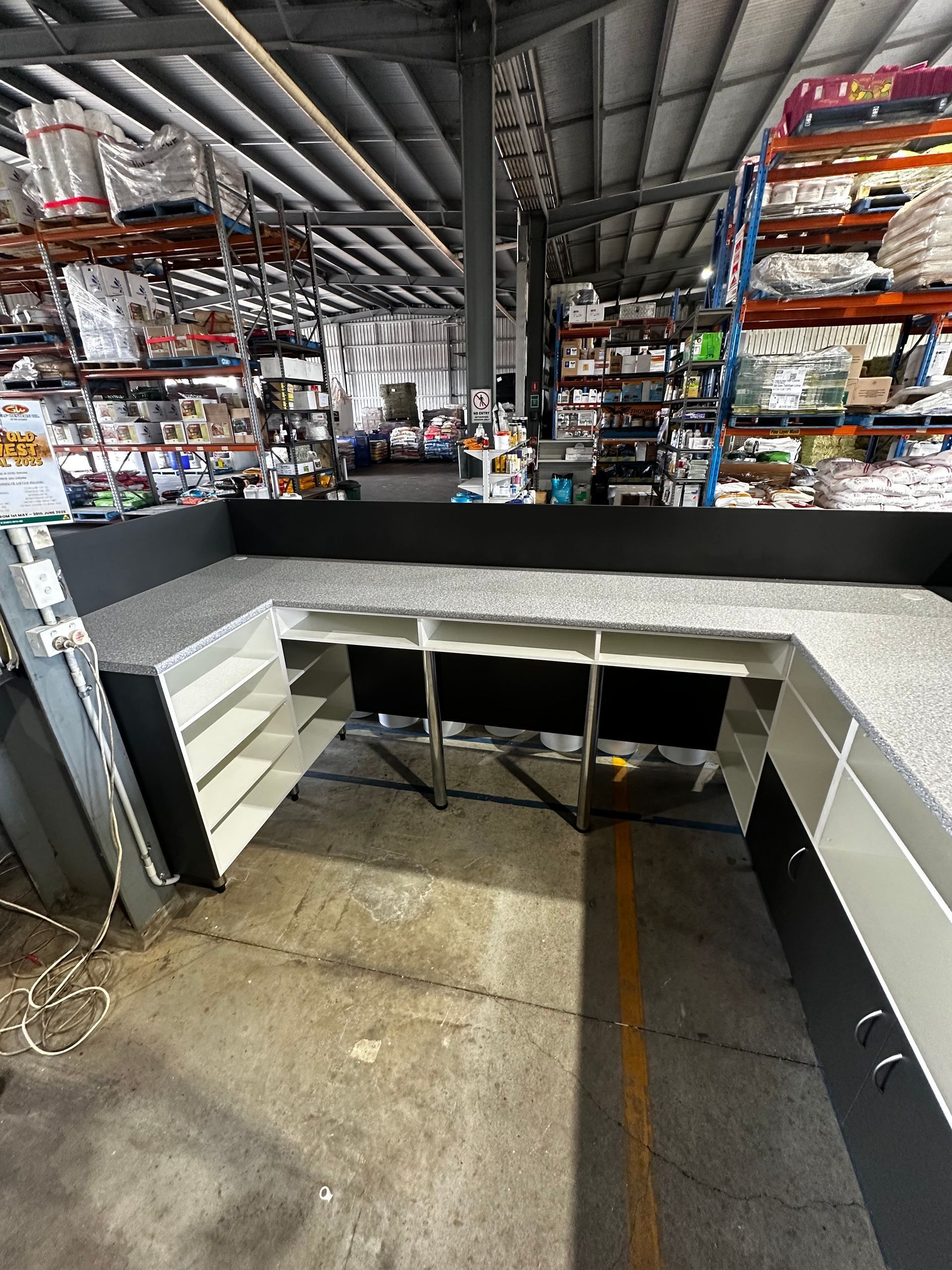 Gray And White Counter With Shelves, In A Warehouse Setting — B & C Cabinets in Mareeba, QLD