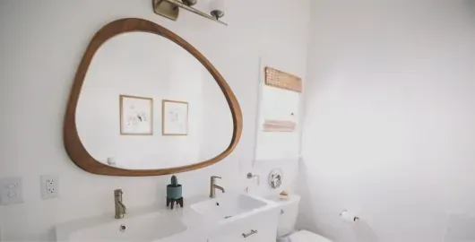 Rounded triangular mirror in bathroom remodel company Huntington Beach