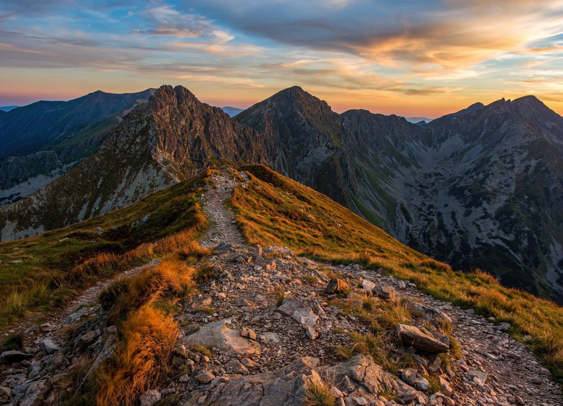 A path leading to the top of a mountain at sunset.