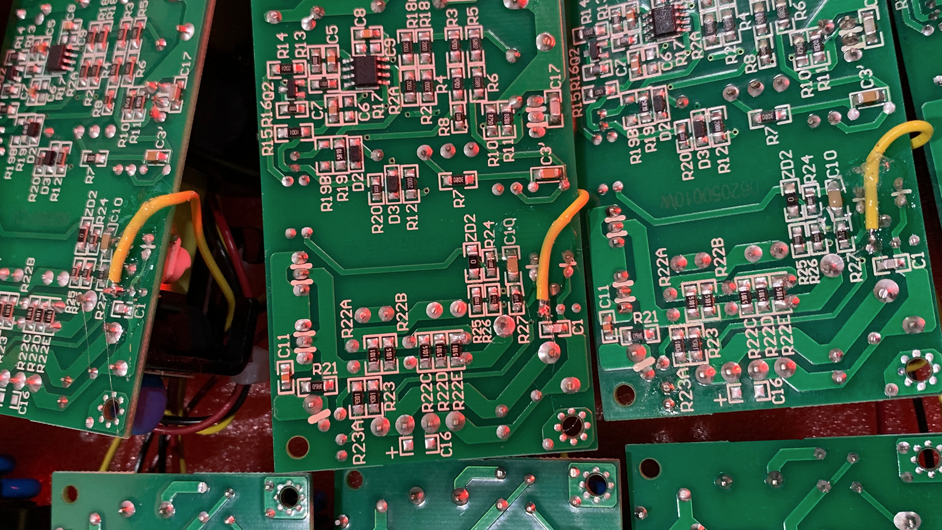 A close up of a motherboard with a lot of wires coming out of it.