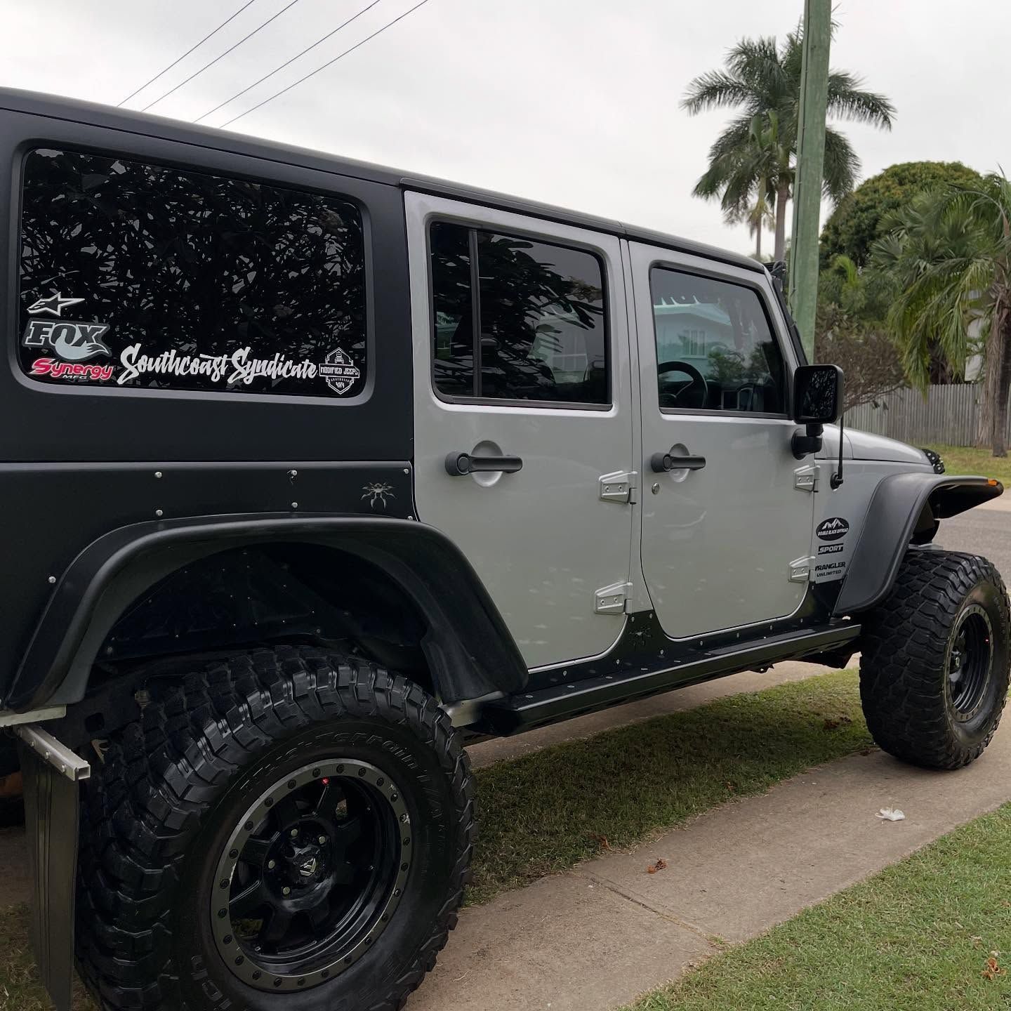 A silver and black jeep is parked on the side of the road — Best Car Detailing in Vincent, QLD