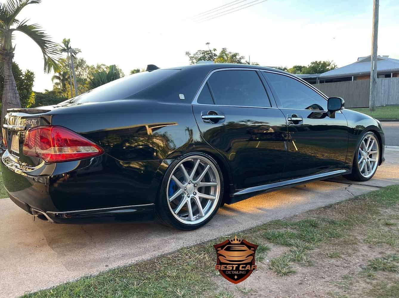 A Black Car is Parked on the Side of the Road — Best Car Detailing in Vincent, QLD
