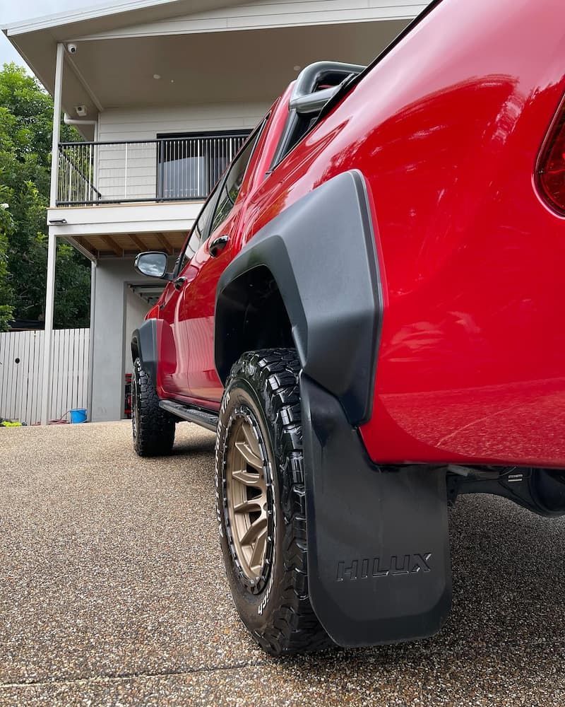 A Red Truck is Parked in Front of a House — Best Car Detailing in Vincent, QLD