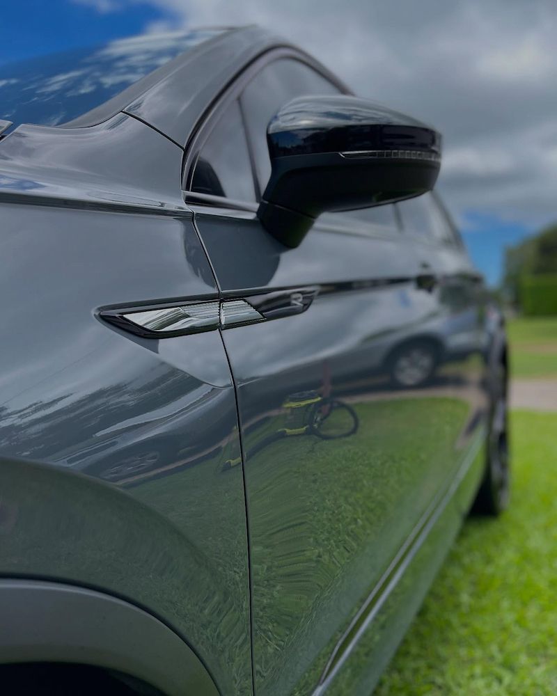 A Gray Car is Parked on the Grass — Best Car Detailing in Vincent, QLD
